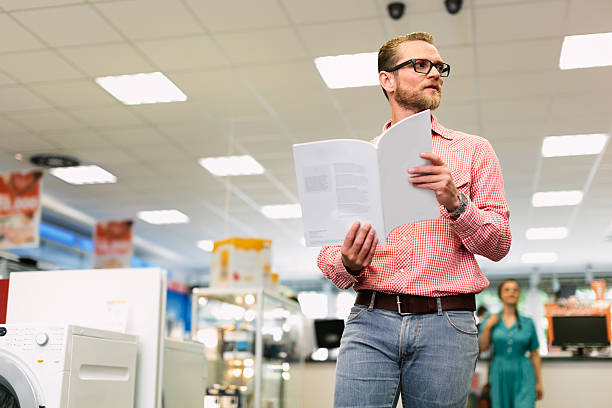 istock Man reading brochure in retail store 471873513