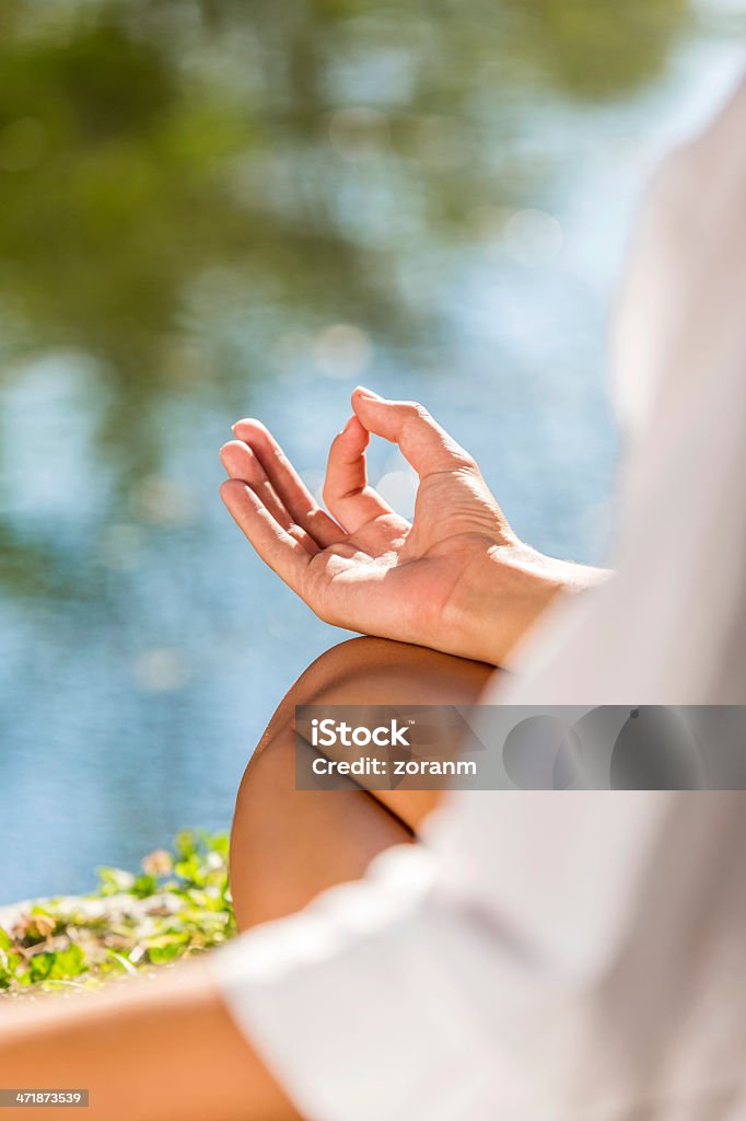 Meditating Close up of a woman doing yoga, lotus position, copy space Adult Stock Photo