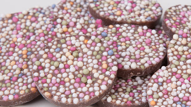 istock Spread of milk chocolate buttons with rainbow sprinkles 471874615