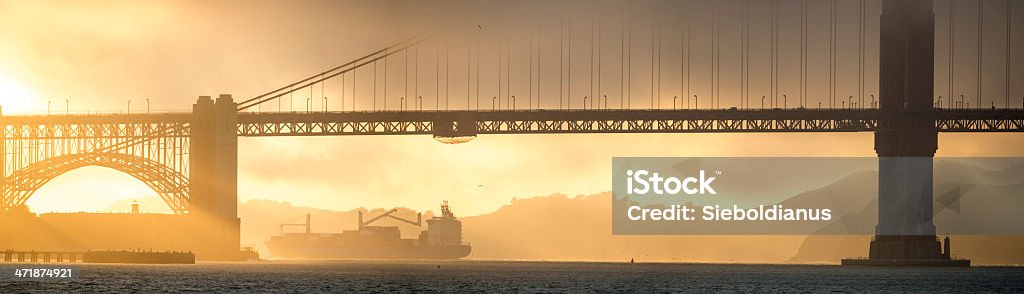 Sunset at Golden Gate, San Francisco Sunset at Golden Gate, San Francisco with Ship leaving the Bay. Yellow Stock Photo