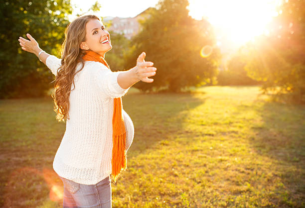 istock Pregnant woman enjoying sun. 471874993