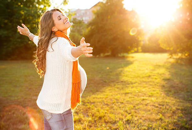 istock Pregnant woman enjoying sun. 471874995