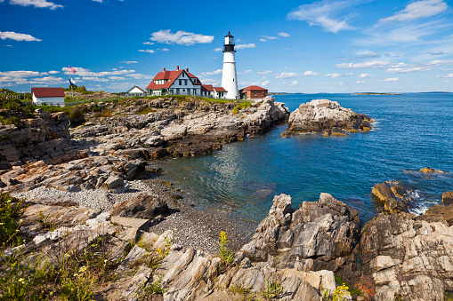 The Portland Head Lighthouse In Maine, USA With Dramatic Rock Formations Overlooking The Atlantic Ocean.