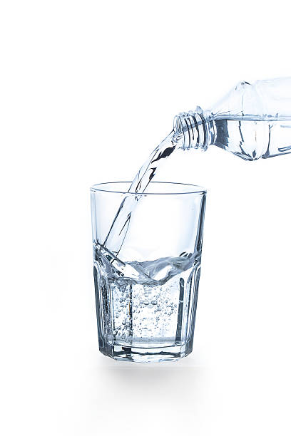 istock Pouring water into glass on white background 471876102