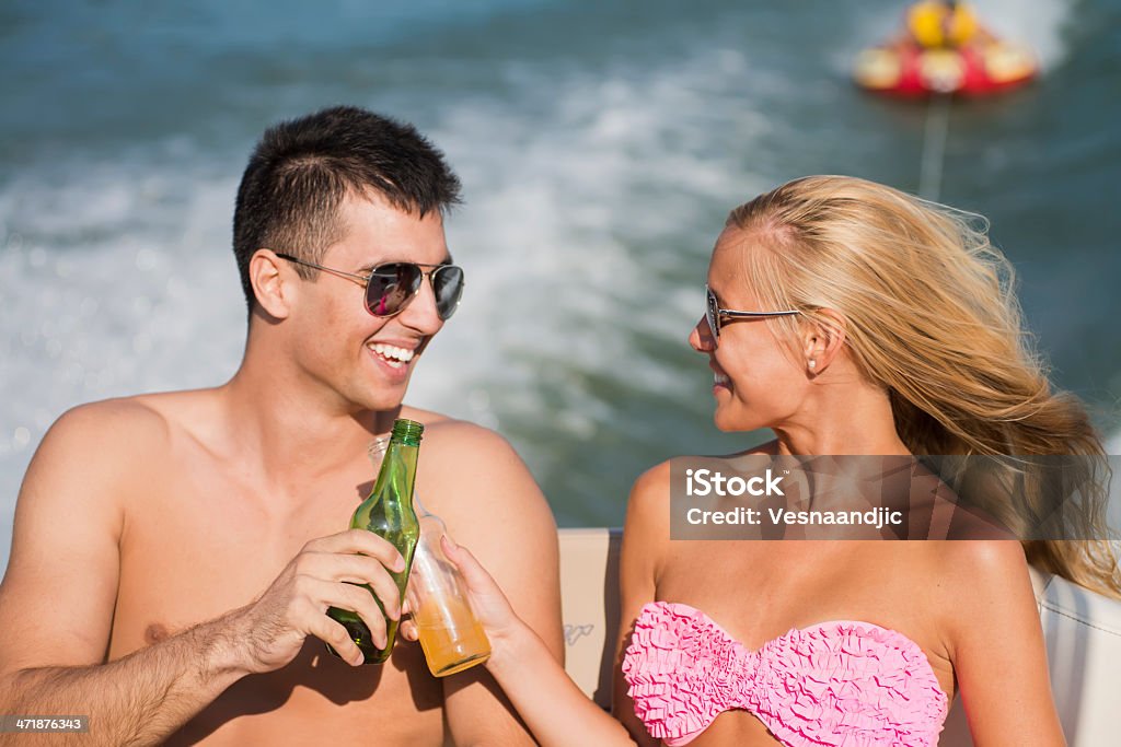 Friends have fun on boat Smiling friends enjoying in driving at motor boat Alcohol - Drink Stock Photo