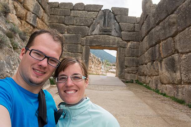 Happy couple posing in front of Lion gate. stock photo