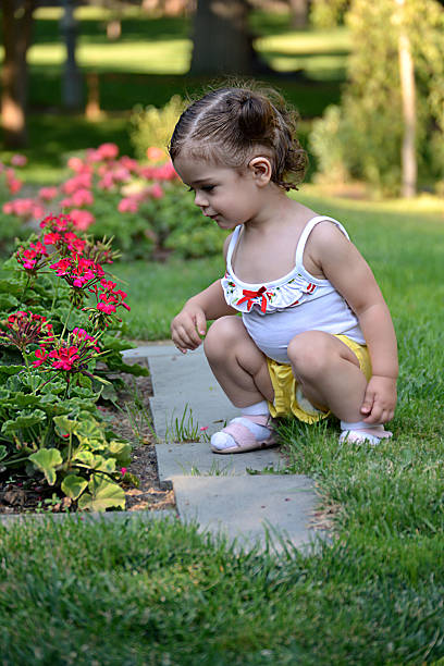 istock baby child playing in garden 471876750