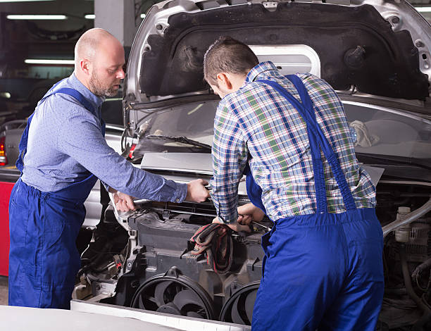 istock Professional mechanics repairing car 471876818