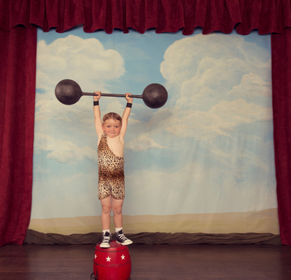 A young boy is super strong and ready to show you his strength.
