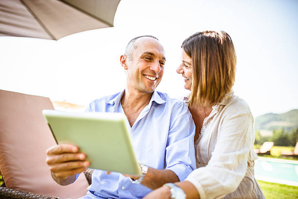 istock couple surfing on the web at resort 471877215