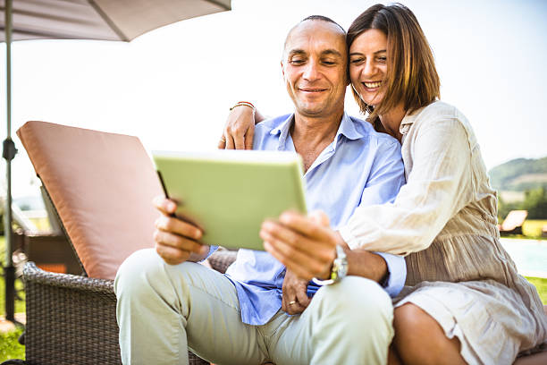 istock couple surfing on the web at resort 471877233