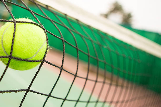 istock Tennis ball in net 471877704