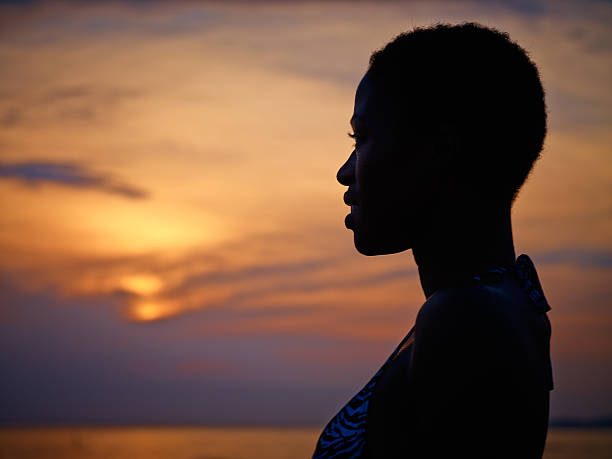 istock siluette of African woman during sunset 471878101