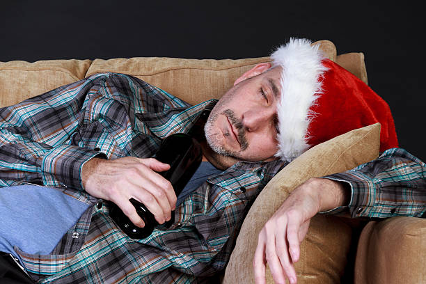 istock Drunk Man Sleeping On a Couch With Bottle of Booze 471878269