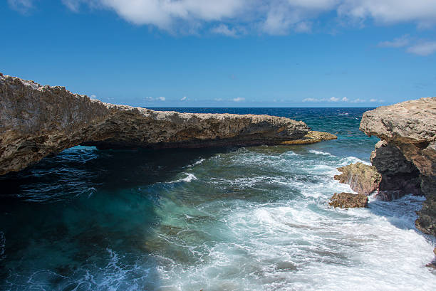 istock Natural bridge on rough coastline 471878370