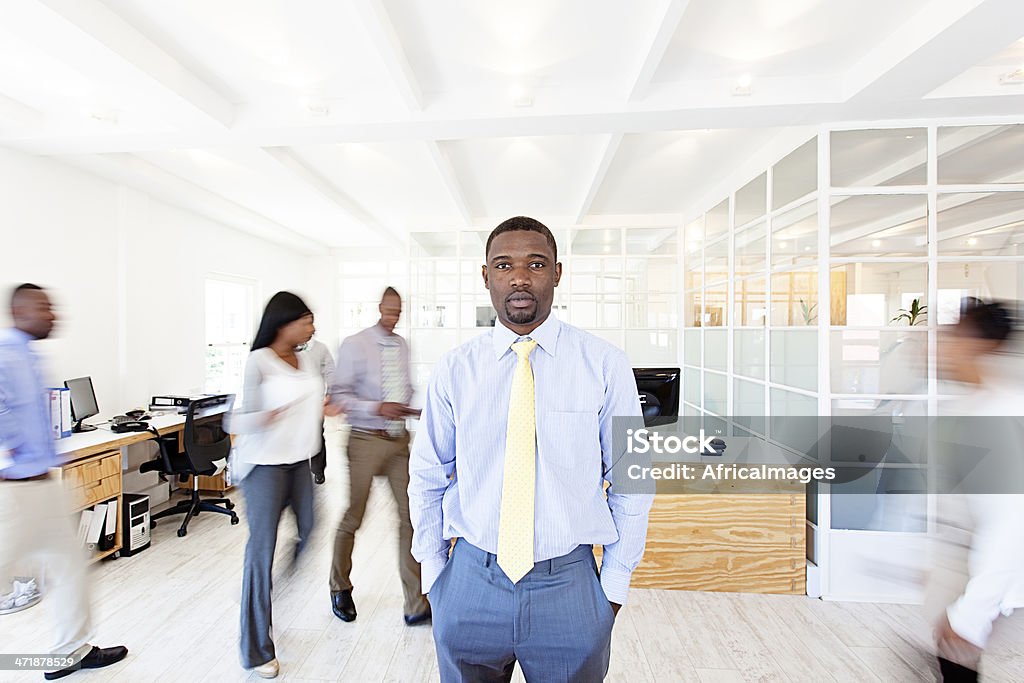 African businessman in the middle of his busy office African businessman in the middle of his busy office. Office Stock Photo