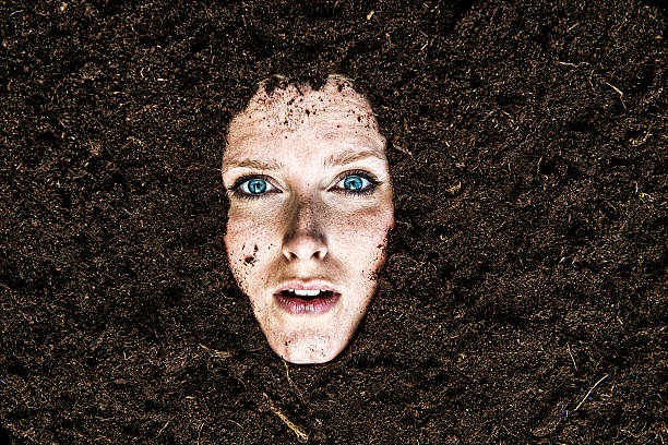 portrait of woman who is buried in a garden - begravd fotografier bildbanksfoton och bilder