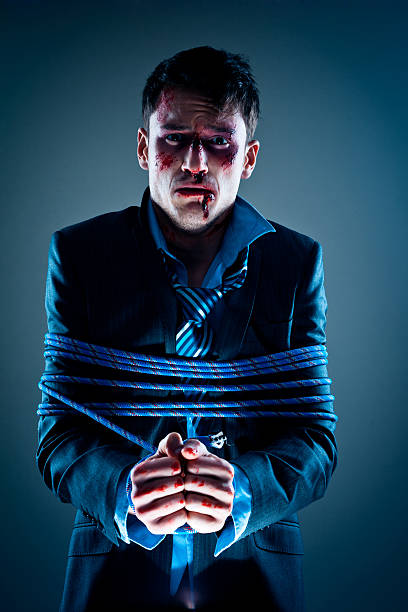 istock Wounded businessman tied up with rope 471879953