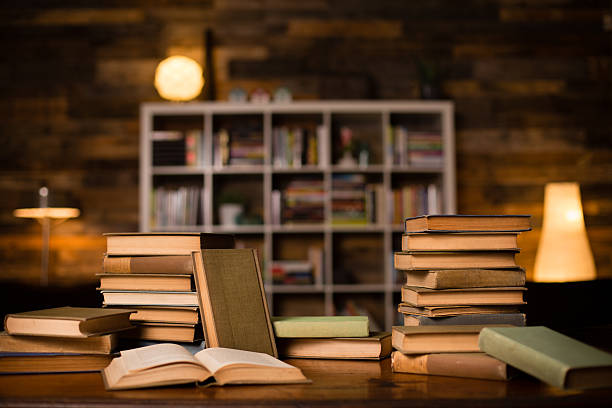istock Vintage Books Sitting on Old Desk, With Shelved Wall Background 471880303