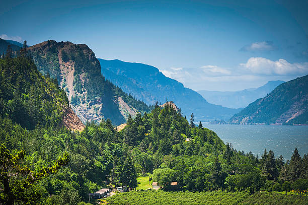 Dramatic view over the farms and forests, rocky bluffs and rail tracks of the Columbia River Gorge, the picturesque National Scenic Area in the Cascade mountains of Oregon and Washington State, USA. ProPhoto RGB profile for maximum color fidelity and gamut.
