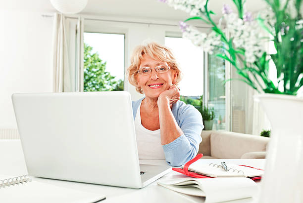 home office - working at home calendar laptop women stock-fotos und bilder