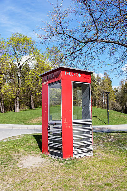 istock Red Norwegian phone box at a junction. 471882060