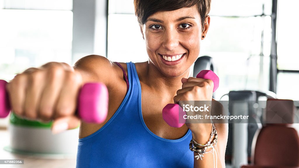 Woman training with dumbbell on gym 20-29 Years Stock Photo