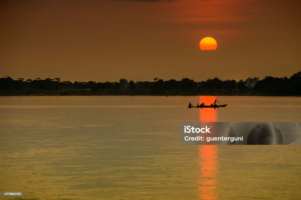 Pirogue (dugout canoe) at sunset, Congo river Silhouette of a typical pirogue (dugout canoe) at sunset at Congo river. Congo River Stock Photo