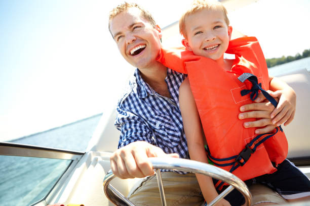 Faster, dad! Young father and son laughing while riding in a speedboathttp://195.154.178.81/DATA/i_collage/pu/shoots/784701.jpg family motorboat stock pictures, royalty-free photos & images