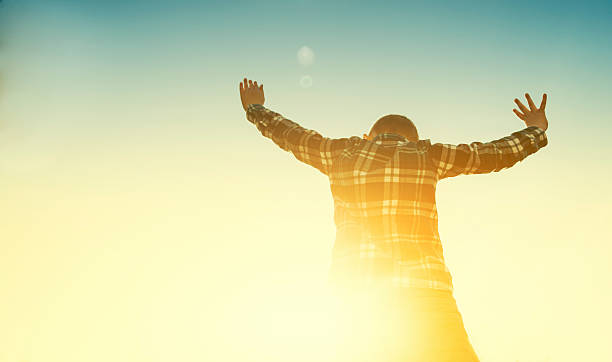 istock Boy dances while the sun sets in the horizon 471883774