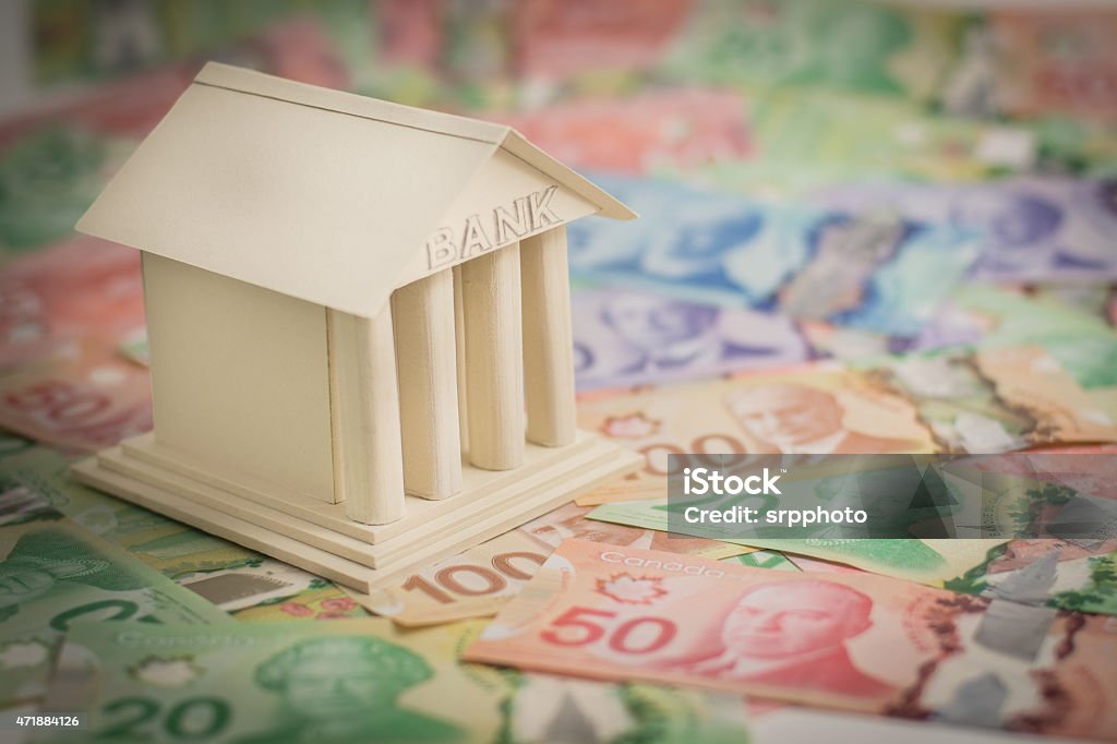 Canadian Bank bank sitting on top of Canadian money Bank - Financial Building Stock Photo