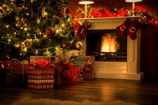 Decorated Christmas tree with presents and fireplace
