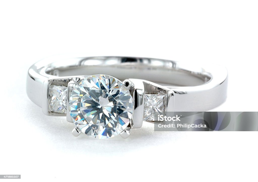 Woman's Diamond and Platinum Wedding Ring Woman's diamond and platinum wedding ring with a round brilliant-cut center diamond.  Isolated on a white background. Diamond - Gemstone Stock Photo