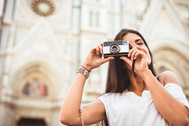 istock Woman photographing with vintage camera 471885743