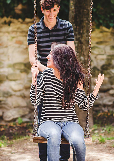 istock woman swinging in summer 471887529