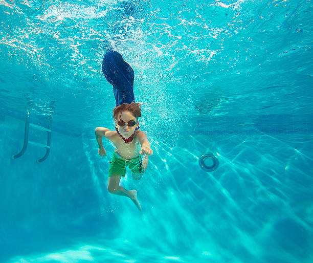 istock boy swimming underwater 471887861