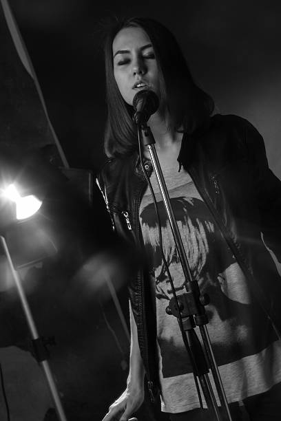 istock girl singing into a microphone in a studio 471888054