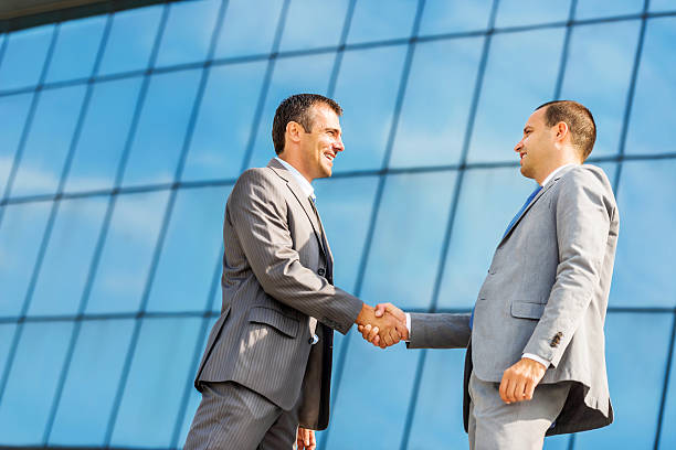 istock Business people shaking hands outdoors. 471888159