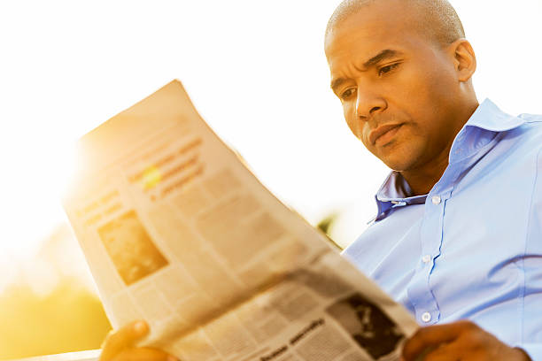 istock Businessman reading newspapers at sunset. 471888735