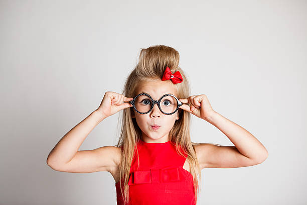 Young Girl Posing on White Background with Glasses stock photo