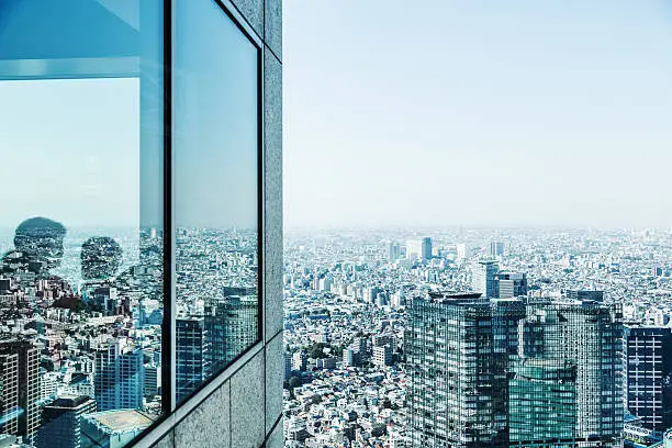People in a Skyscraper overlooking Tokyo, Japan.