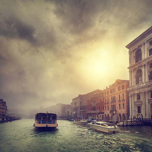 foggy morning in Venice - a vaporetto and a motorboat on the Grand Canal