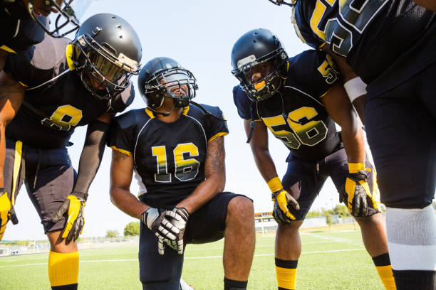 istock Football team discussing strategy during game 471890029