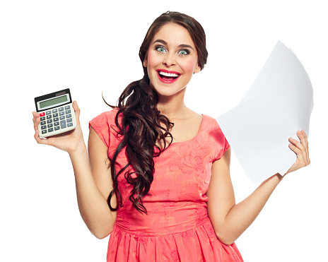 Young woman holding papers and calculator in hands and laughing at the camera. Studio shot on a white background.