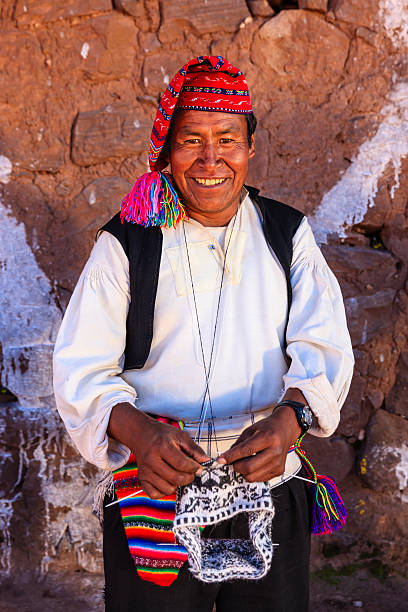 istock Man knitting on Taquile Island, Lake Titicaca, Peru 471890323