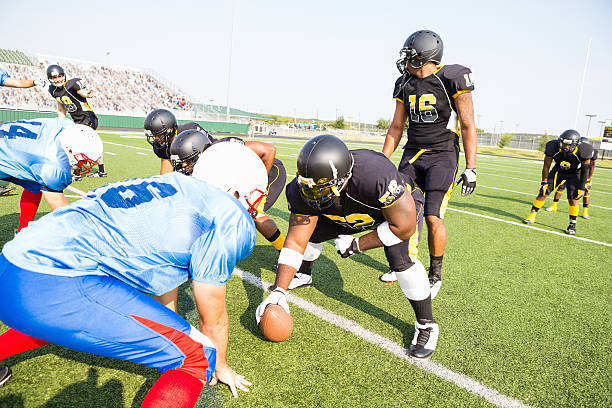 istock Football players facing down opposing team during pro game 471890403