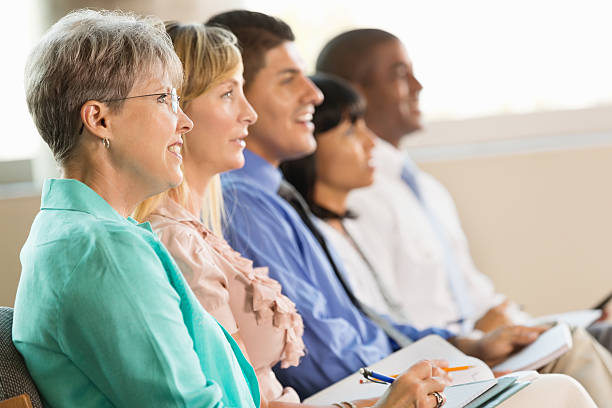 istock Diverse group of attendees taking notes during seminar at conference 471890493