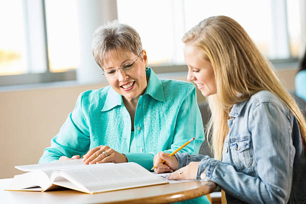istock High school student being tutored by experienced teacher 471891105