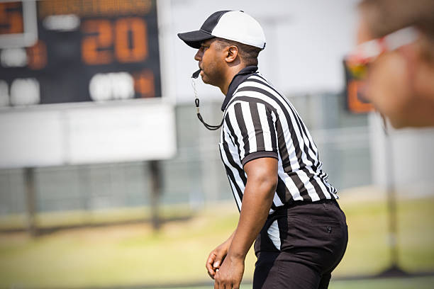 istock Football referee blowing whistle during game 471891133