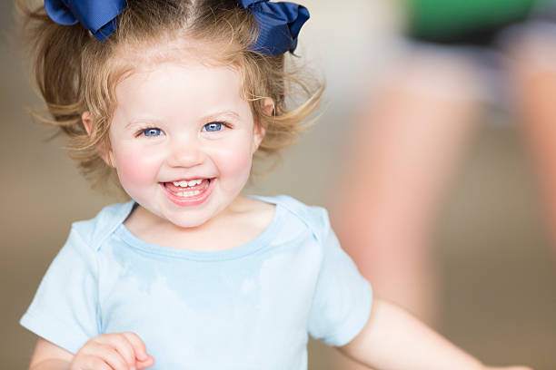 Cute toddler girl laughing and smiling Cute toddler girl laughing and smiling blue eyes photos stock pictures, royalty-free photos & images